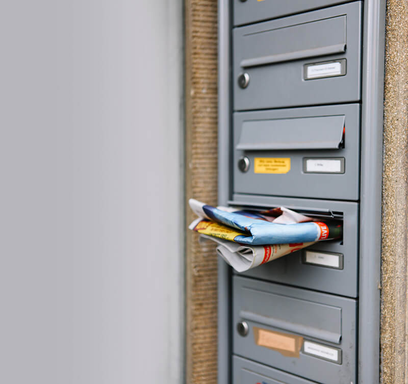 A mailbox overflowing with junk mail