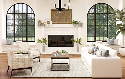 Interior of a home's living room with a fireplace, two chairs, and a couch.