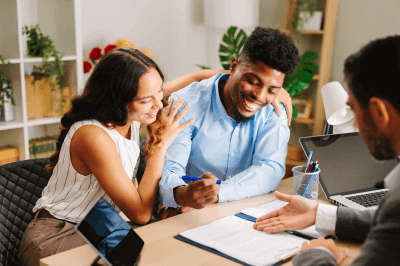 Couple sits down with mortgage loan officer to calculate how much it would cost for them to refinance.