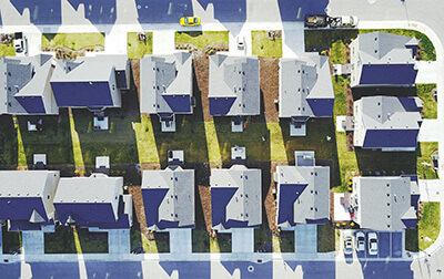 A birds-eye view of a street with multiple homes.