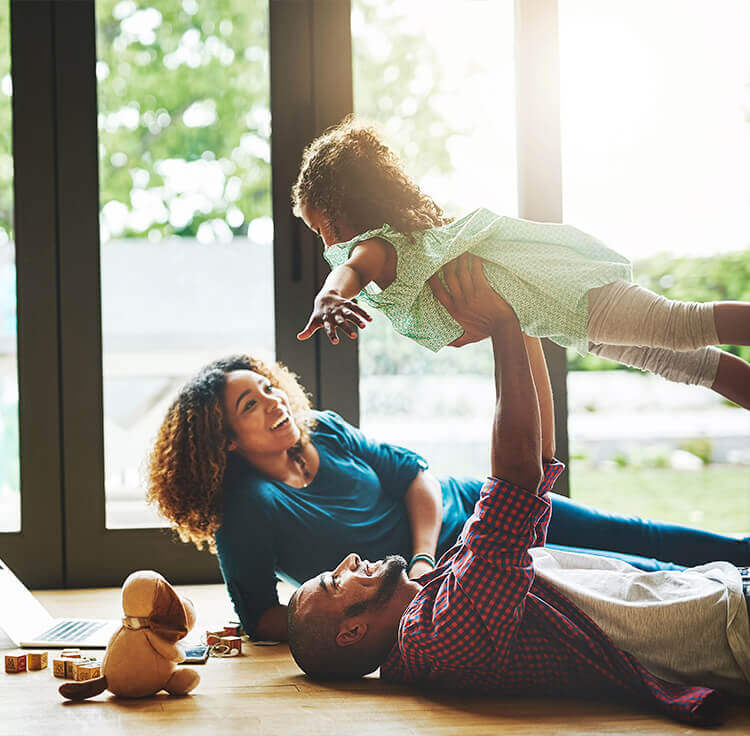 A veteran and family playing after inquiring how to apply for a VA home loan to buy a home