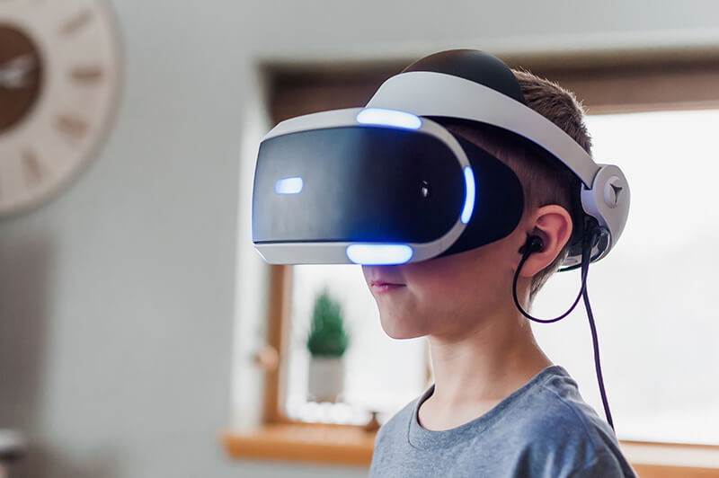 A kid wearing virtual reality goggles