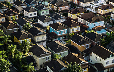 A birds-eye view of a neighborhood with multiple colorful houses.