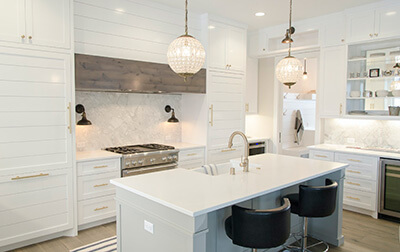 A kitchen with white cupboards and countertops.