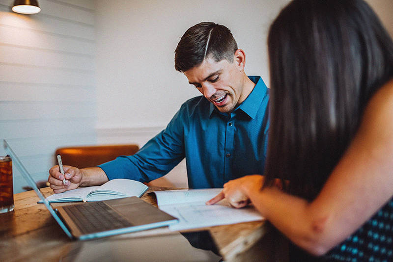 A buyer and renter going over house listings