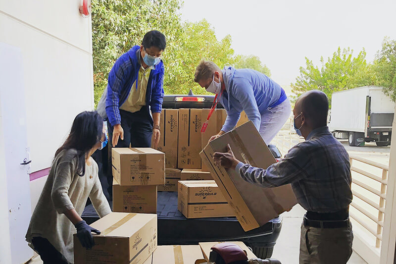 Team of people loading boxes into a truck