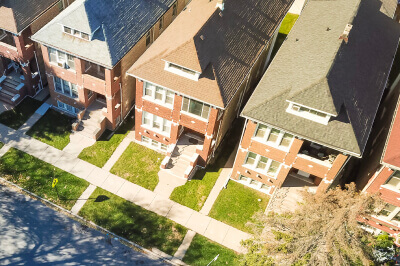 Exterior of street filled with owner-occupied, multi-family homes of 2-4 unit properties.