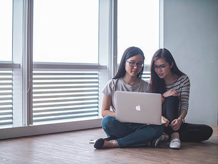 Couple reading tips about buying their first home