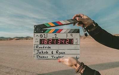 A slate board being held on a video set.