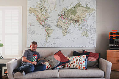 Man sitting on his couch looking into how to improve his finances